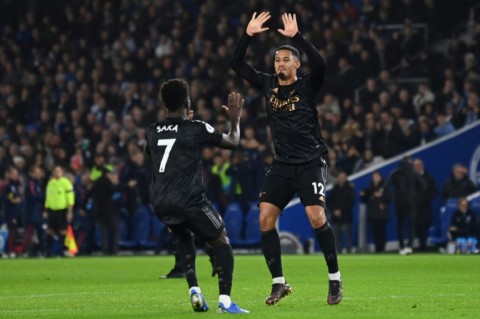 Arsenal's William Saliba (R) and Bukayo Saka celebrate against Brighton 