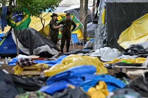 Soldiers dismantle the camp set up by supporters of Brazil's far-right ex-president Jair Bolsonaro in front of the Army headquarters in Brasilia