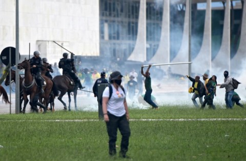 Supporters of former president Jair Bolsonaro clash with security forces during an invasion of the Planalto Presidential Palace in Brasilia