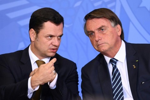 Brazilian authorities have issued an arrest warrant related to the capital riots for former justice minister Anderson Torres, seen here speaking in June 2022 with then-president Jair Bolsonaro