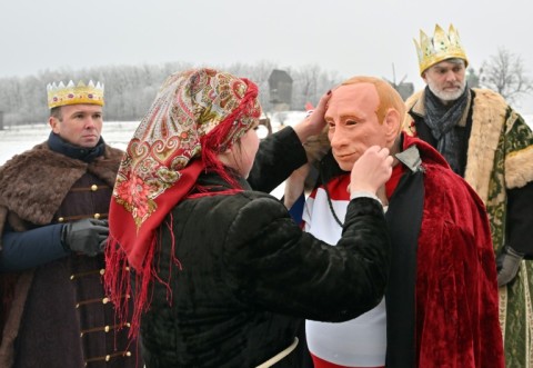 A man wearing a Vladimir Putin mask takes part in a performance during the celebration of Malanka in Pyrogove village, near Kyiv on Saturday 