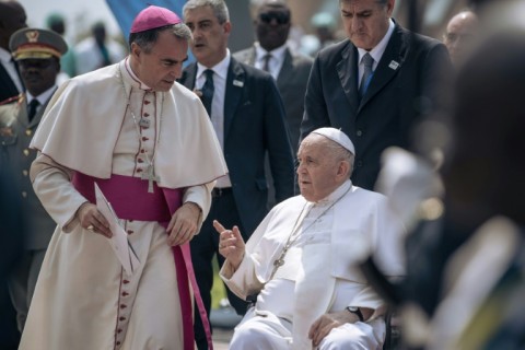 Pope Francis is escorted in a wheelchair to the plane for his departure from the Democratic Republic of Congo 