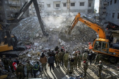 Rescue workers search for survivors in the town of Jableh in northwestern Syria