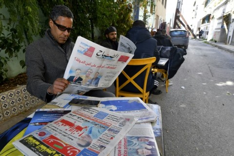 A man in Tunis reads the latest news after a wave of arrests that has targeted activists, former lawyers and a prominent businessman