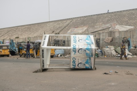 A traffic control booth lies on its side after angry protesters took to the streets of Lagos