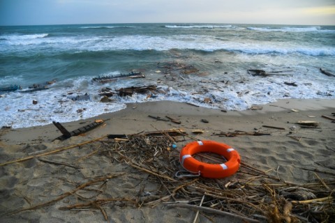 Bodies, shoes and debris have washed up along a stretch of southern Italy shoreline after a migrant boat sank