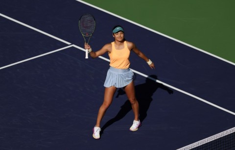 Britain's Emma Raducanu celebrates her first-round victory over Danka Kovinic of Montenegro at the Indian Wells hard court tennis tournament