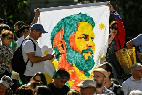 Supporters of Chile's President Gabriel Boric celebrate his first year in office, outside the presidential palace in Santiago, on March 11, 2023