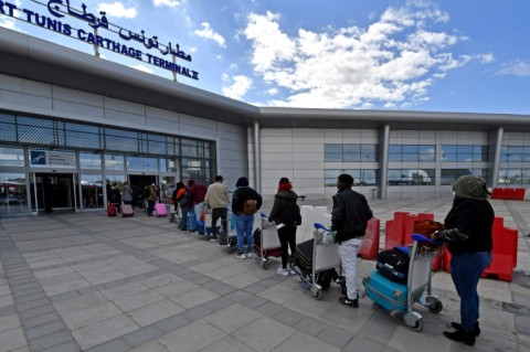 Migrants arrive at Tunis-Carthage International airport on March 7, 2023 as they prepare to leave Tunis on a repatriation flight