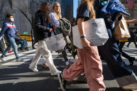 Pedestrians stroll along 5th Avenue in Manhattan, a premier shopping street in New York City  