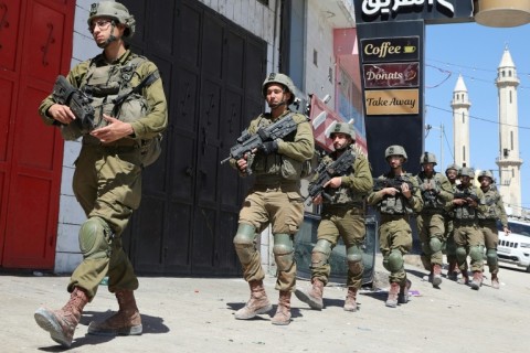 Israeli troops patrol in the occupied-West Bank town of Huwara 