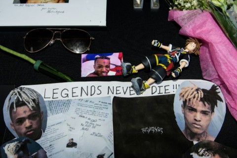 Fans leave items at a makeshift memorial outside XXXTentacion Funeral & Fan Memorial in Florida on June 27, 2018 