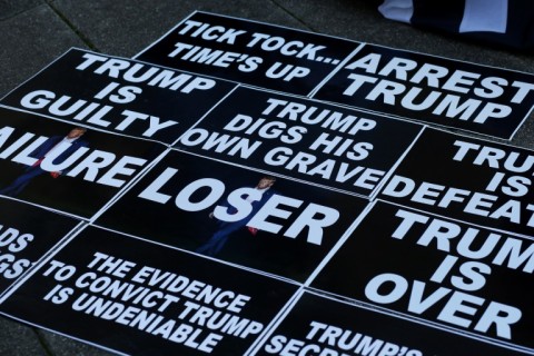 Anti-Trump placards displayed outside the Manhattan District Attorney's office in New York City on March 21, 2023.