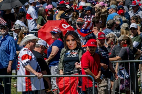 People wait in line at the Waco Regional Airport ahead of former president Donald Trump's arrival on March 25, 2023 in Waco, Texas