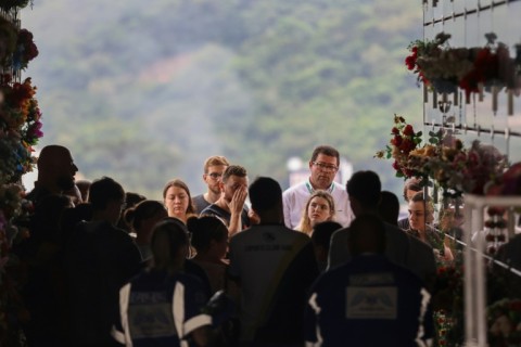 Devastated family members gathered to mourn victims of an attack on a Brazilian preschool, as residents left flowers and teddy bears outside the school