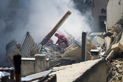 Intense heat was keeping firefighters and rescue dogs from combing the rubble