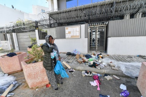 A migrant woman cries after Tunisian police dismantled a camp outside the UNHCR headquarters in Tunis 