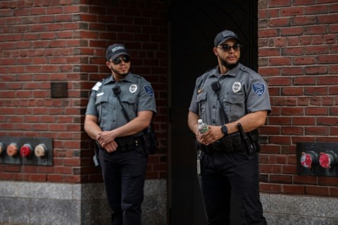 Security guards stand outside the entrance to a Boston courthouse where Jack Teixeira, accused of leaking US secrets, made his first court appearance