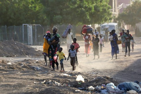 People flee their neighbourhoods amid fighting between the army and paramilitaries in Khartoum