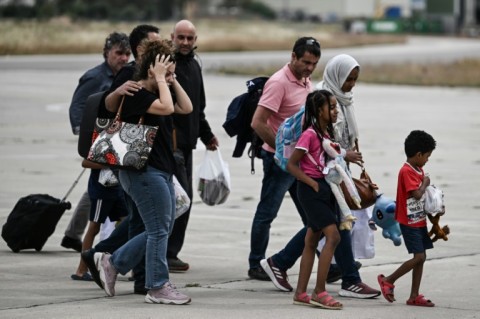 Greek nationals from Sudan arrive with a military C-27 plane at the military airport of Elefsina, south of Athens