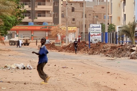 Foreigners fleeing Sudan disembark from a Saudi evacuation ship after it docks in the Red Sea port of Sudan