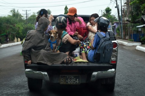 People evacuate in Sittwe in Myanmar's Rakhine state on May 13, 2023, ahead of the expected landfall of Cyclone Mocha on May 14