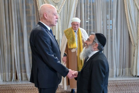 Tunisian President Kais Saied (L) greeting his country's Chief Rabbi Haim Bittan following a deadly shooting attack