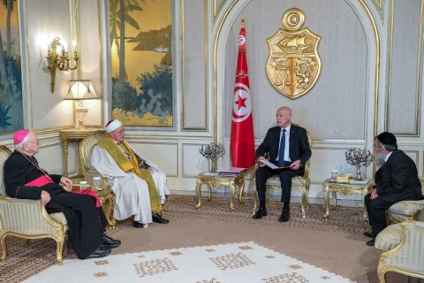 Tunisian President Kais Saied, seated next to the flag, meets Bishop Ilario Antoniazzi, Chief Rabbi Bitten Haiem and Mufti Hichem Ben Mahmoud at the Carthage Palace in Tunis