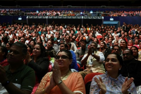 Members of the local Indian community listen to a speech by India's Prime Minister Narendra Modi during an event at the Qudos Arena in Sydney on May 23, 2023. 