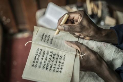 The scribes use different pens for each colour used in the text