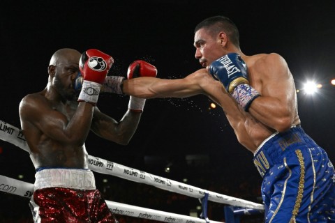 Australian boxer Tim Tszyu (R) has had surgery, reportedly for a dog bite