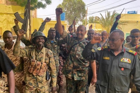 Sudan's army chief Abdel Fattah al-Burhan cheering with soldiers as he visits some of their positions in Khartoum