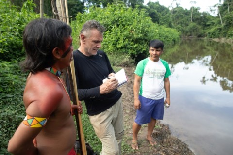 Dom Phillips (C) is pictured talking to two indigenous men in Aldeia Maloca Papiu, in Brazil's Roraima state, in 2019