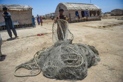 Villagers wait to be evacuated to government relief camps before the arrival of the cyclone,  in Sujawal district, Sindh province