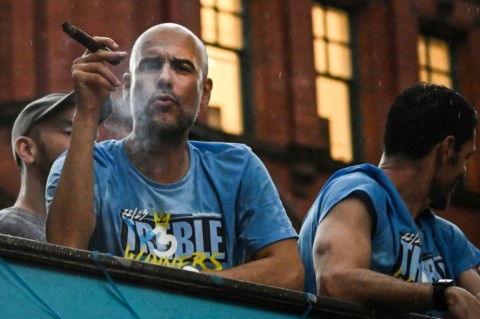 Manchester City manager Pep Guardiola celebrated winning the treble during a city centre parade on Monday