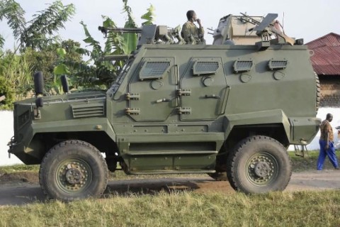 A Uganda People's Defence Force (UPDF) armoured personnel carrier stands guard outside the school in Mpondwe