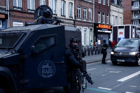 Officers with the elite RAID police unit patrol in Lille