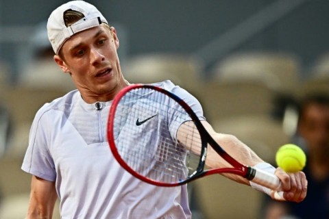 Hat's the way to do it: Canada's Denis Shapovalov plays a return to Carlos Alcaraz at the French Open