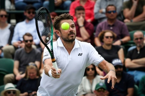 Senior service: Stan Wawrinka returns the ball to Argentina's Tomas Martin Etcheverry 