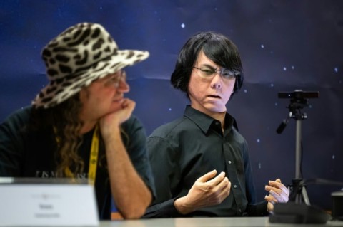 SingularityNET chief executive Ben Goertzel sat next to tele-operated android Geminoid HI-2, modelled on creator Professor Hiroshi Ishiguro