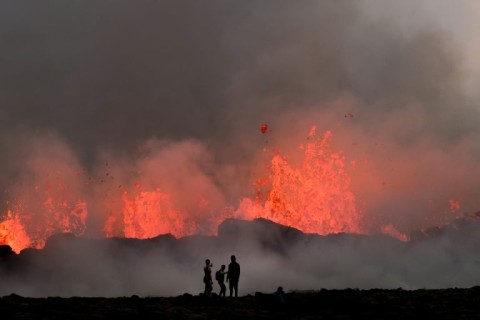 People watch lava at a volcanic eruption at Litli Hrutur near Reykjavik, Iceland 