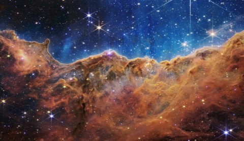 The so-called Cosmic Cliffs of a star-forming region in a part of space called the Carina Nebula, one of the James Webb Space Telescope's first released images