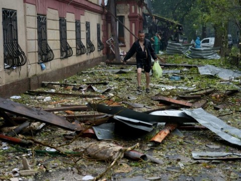 A local resident walks past a destroyed residential building in Mykolaiv