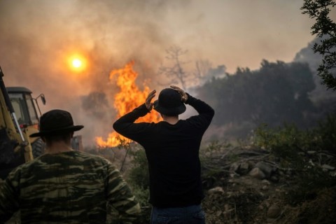 Wildfires have been raging in Greece amid scorching temperatures, forcing mass evacuations in several tourist spots including on the islands of Rhodes and Corfu