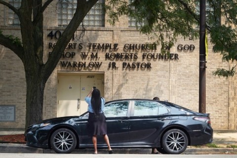 A woman takes a picture of the Roberts Temple Church of God in Christ in Chicago, which will be designated by the White House as part of a three-part memorial to Emmett Till, a 1955 lynching victim