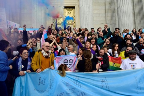 Spanish activists celebrate a vote in favour of the country's transgender rights bill