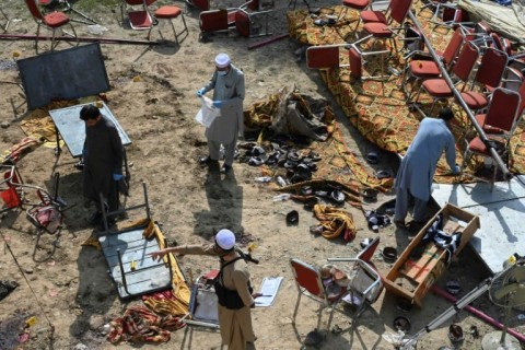 Investigators examine the site of Sunday's suicide bomb blast