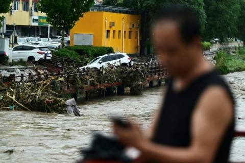 At least 11 people are known dead after heavy rains wreaked havoc in Beijing, state media has said