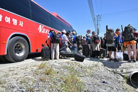 Scouts prepare to leave the  World Scout Jamboree camspite in South Korea's North Jeolla province, which has been plagued by problems is being evacuated as a typhoon approaches