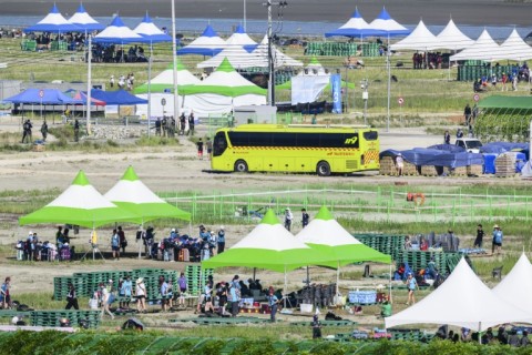 Scouts prepare to leave the  World Scout Jamboree camspite in South Korea's North Jeolla province, which has been plagued by problems is being evacuated as a typhoon approaches